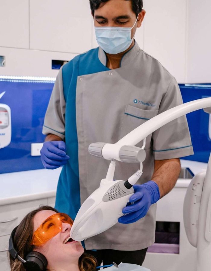 Teeth whitening with a patient and a dentist at 7 Pearls Dental